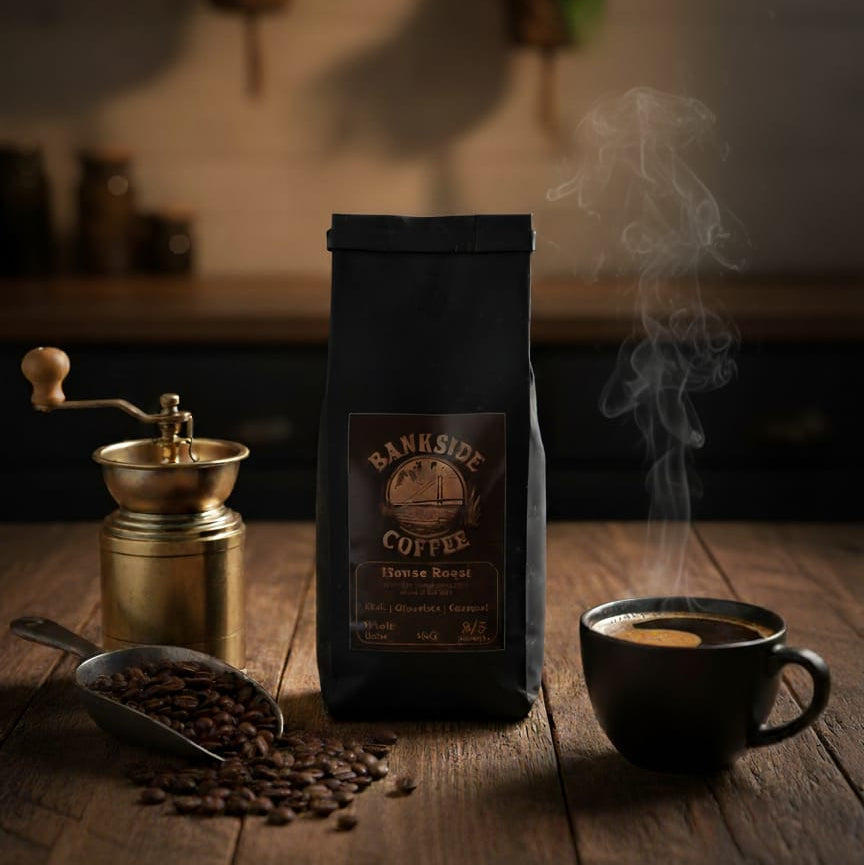 A steaming cup of coffee next to a large bag of coffee on a wooden table